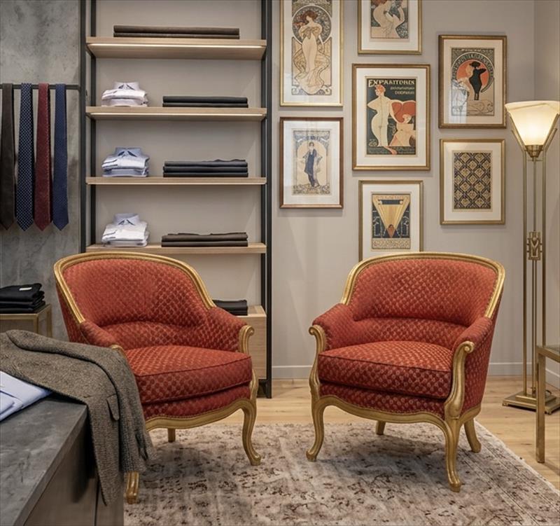 Pair of golden and sinuous armchairs 
